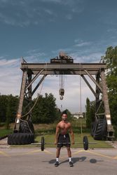 Black guy with barbell in outdoor gym