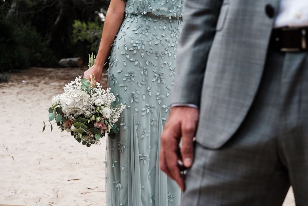 Happy married couple in wedding clothing at forest