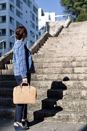 Businesswoman climbing up street stairs