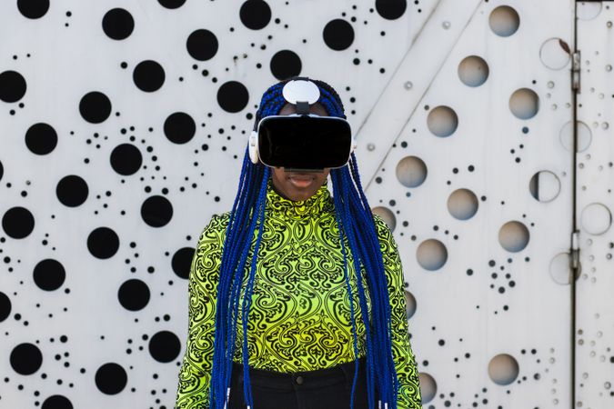 Black woman in VR headset in city