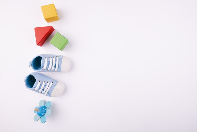 Baby shoes and toys with copy space