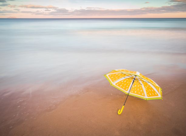 Umbrella on beach near sea