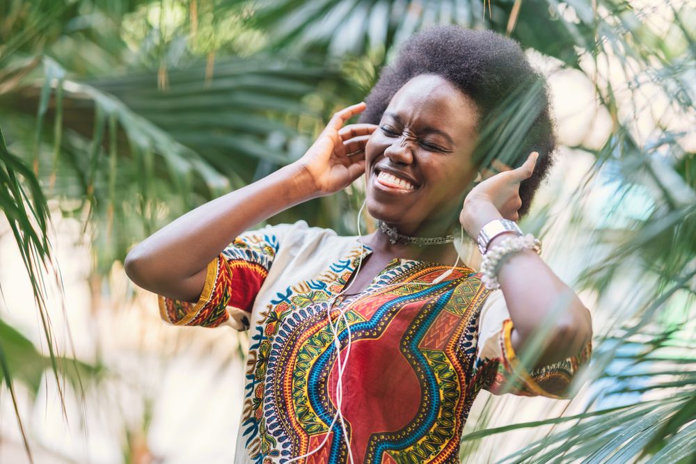 Smiling Black woman listening to music