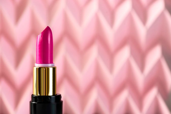 Lipstick on raised pink chevron. Product and make up concept