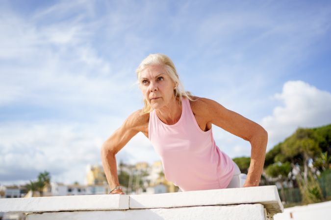 Older female doing push ups or press ups exercise