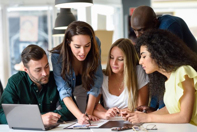 Multi-ethnic group working in office together
