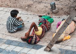 Back view of three children laying on floor outdoor 5nMwQ0