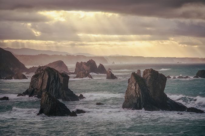 Coastal rock on beach and overcast sky