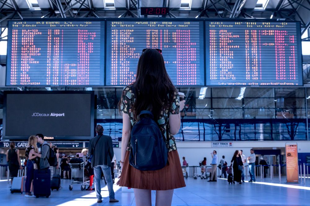 Back view of woman with backpack in the airport