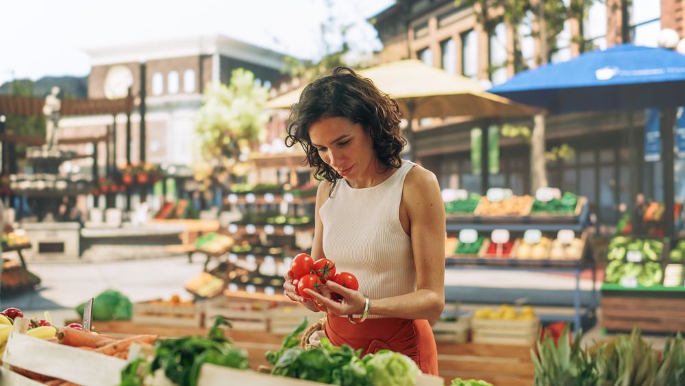 Brazilian Female Customer Buying Sustainable Organic Tomatoes From a Local Farmers Stall.