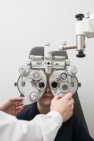 Optician testing a boy's eyes