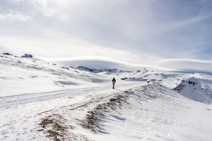 One person walking through Sierra Nevada ski resort in winter