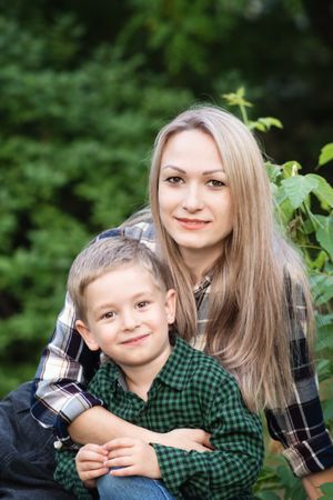Portrait of mother spending time with son in backyard