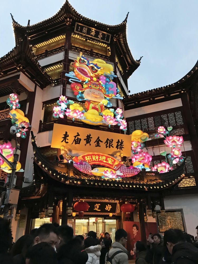 People walking on street between temples in Shanghai Shi, China
