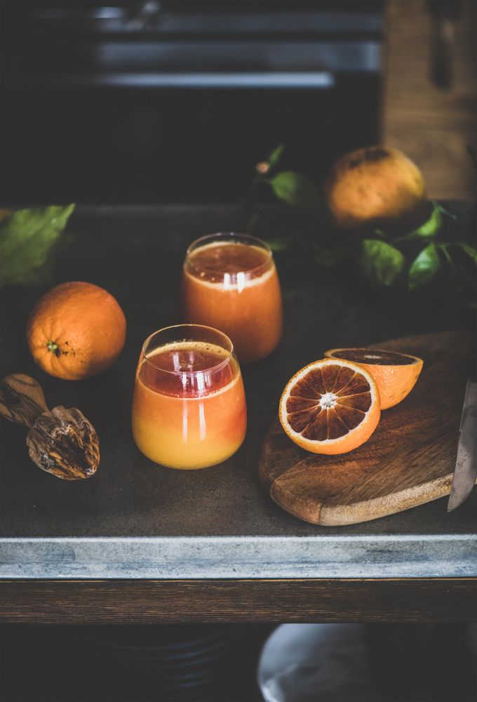 Two glasses of freshly squeezed blood orange juice, vertical composition