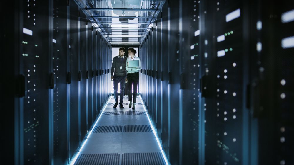 Female IT Technician and Male Server Engineer Talk and Discuss.