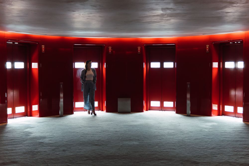 Unrecognizable woman standing in foyer with lifts