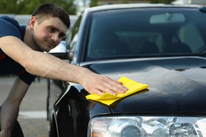 A man rubs a car. Car wash. Clear car concept
