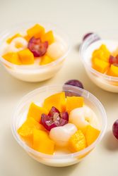 Three bowls of pudding fruit with a flower like shape from grape