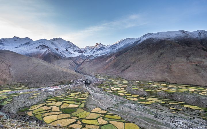 Green tiles near snowy hills
