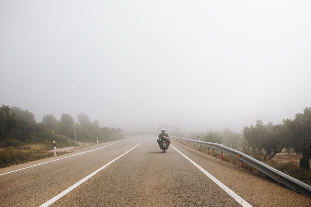 Motorcyclist riding into the fog