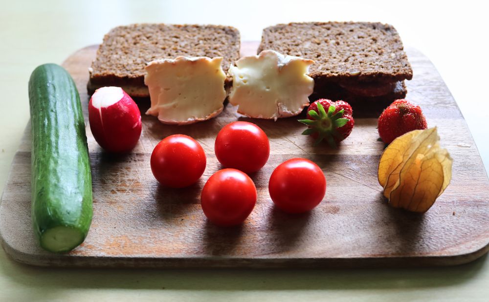 Close view on a healthy german breakfast with sandwiches, tomatoes and cucumbers
