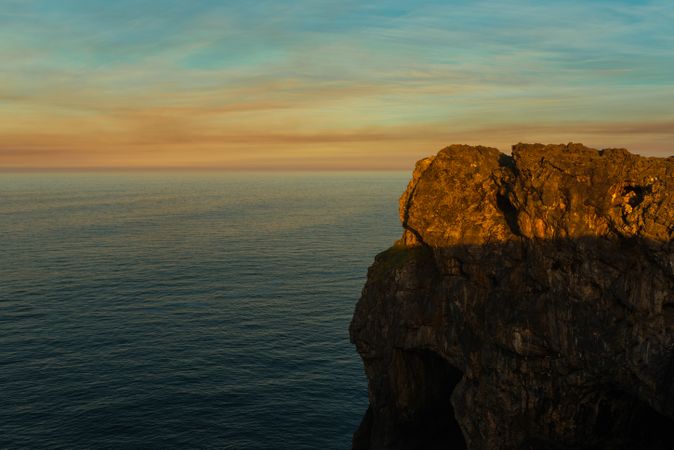 Majestic cliffs of ocean coastline in sunset