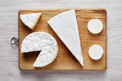 Assortment of cheese on bread board