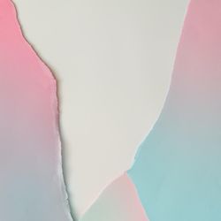 Pieces of ripped pastel colored paper in pattern