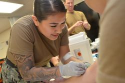 Jacksonville, FL - USA, July 17, 2019: Nurse placing intravenous tubing in patient’s arm