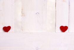 Red hearts apart on a fence