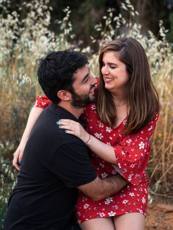 Young happy couple embracing in beautiful garden