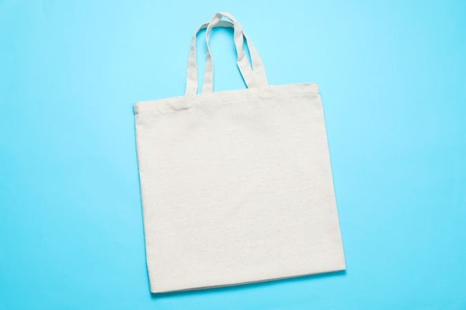 Eco bag on color background, space for text