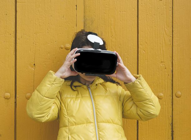 Girl in yellow jacket with VR headset