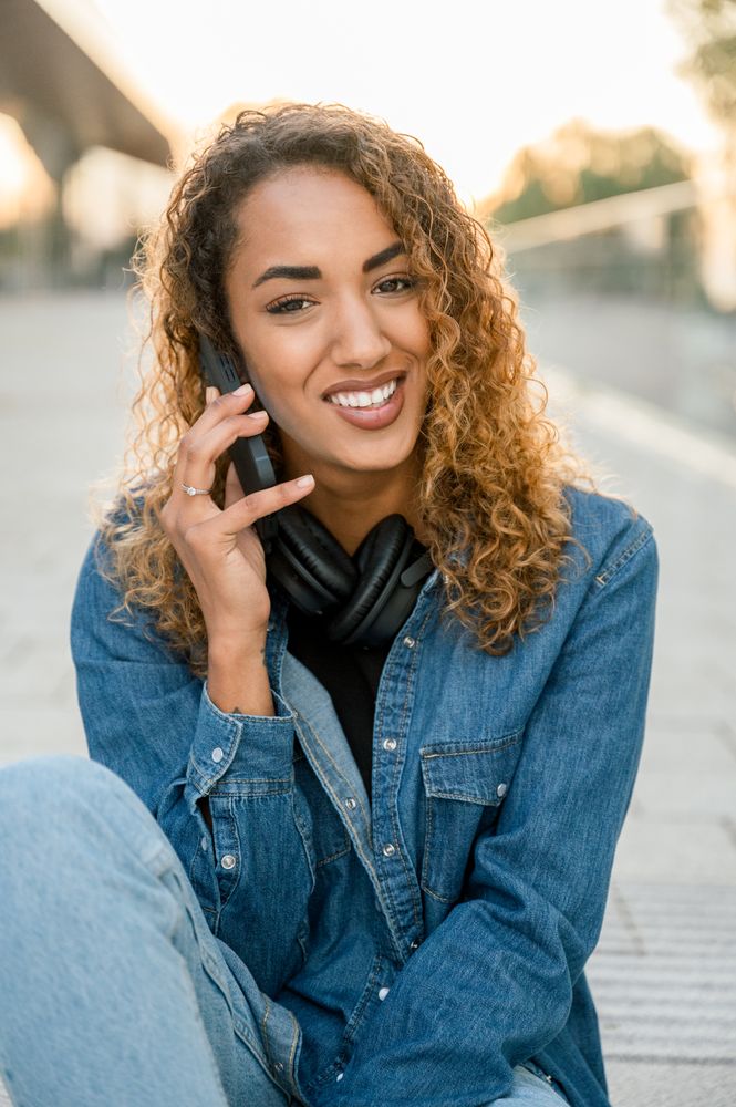 Smiling woman talking on smartphone