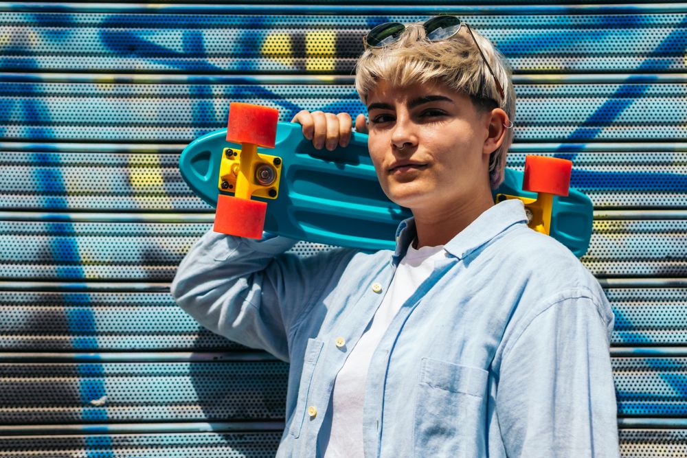 woman with a skate and short hair looking at camera