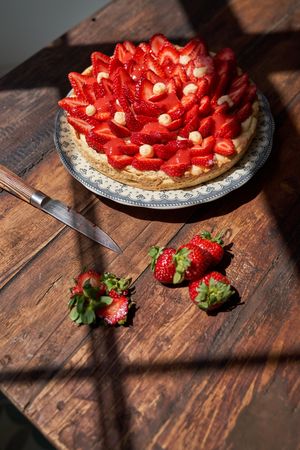 Plate with decorated fresh berries on wooden table