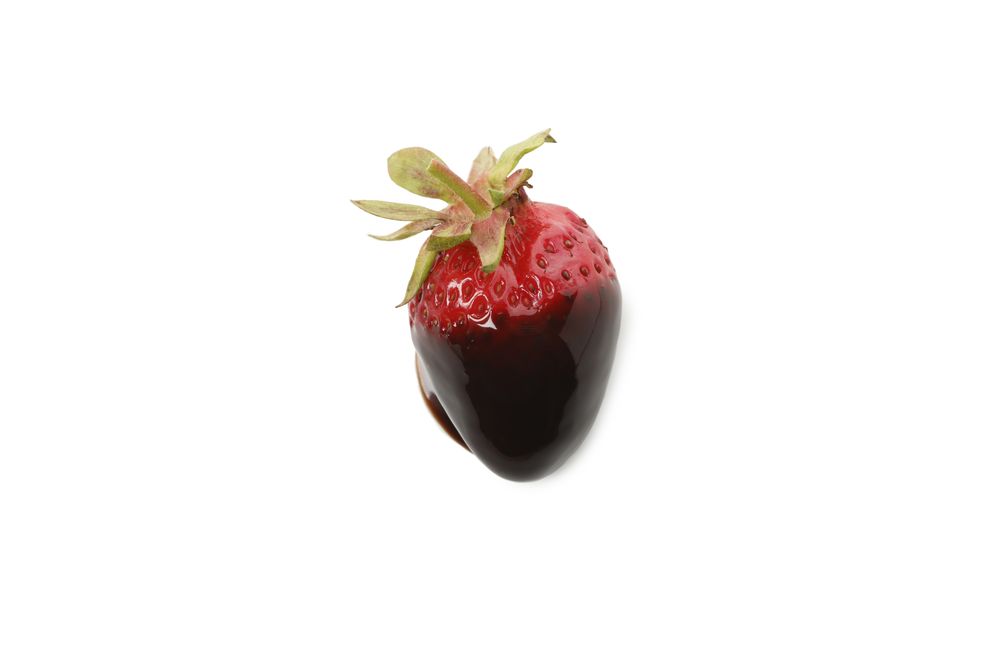 Chocolate fondue. Strawberry in chocolate sauce isolated on plain background