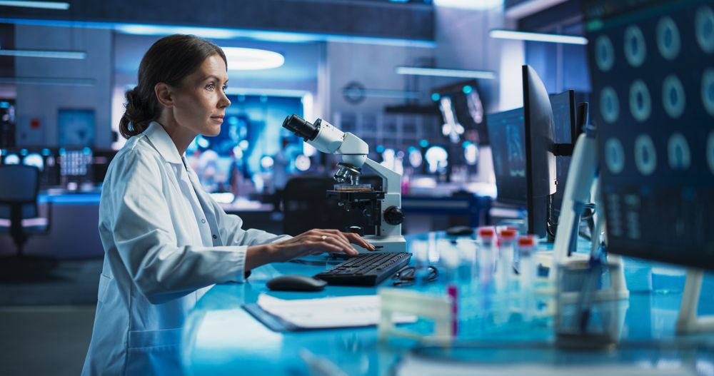 Medicine Development Laboratory: Female Scientist Using Microscope, Analyzes Petri Dish Sample.