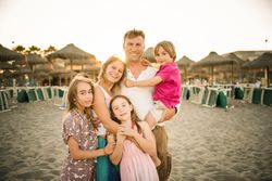Beautiful happy family with children on beach