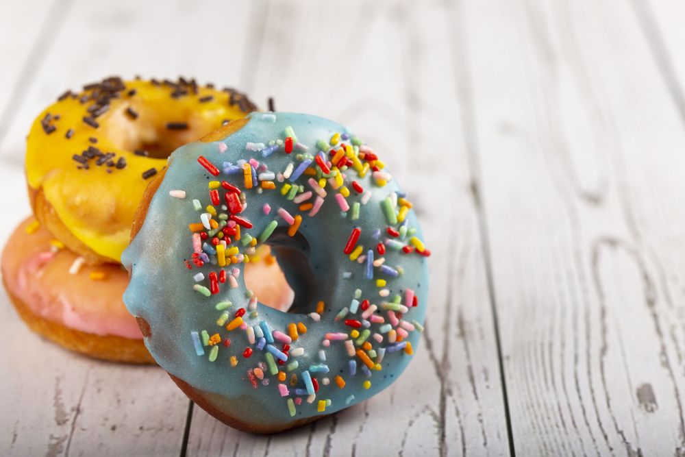 Delicious assorted colorful donuts on the table.