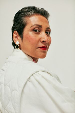 Close up portrait of woman in cream-colored jacket
