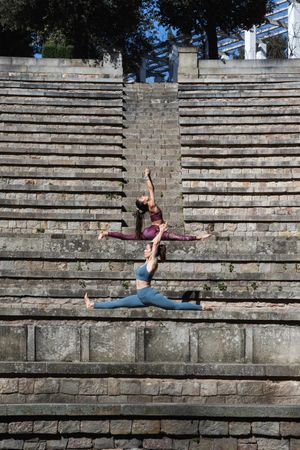 Flexible women sitting in Splits pose and doing yoga