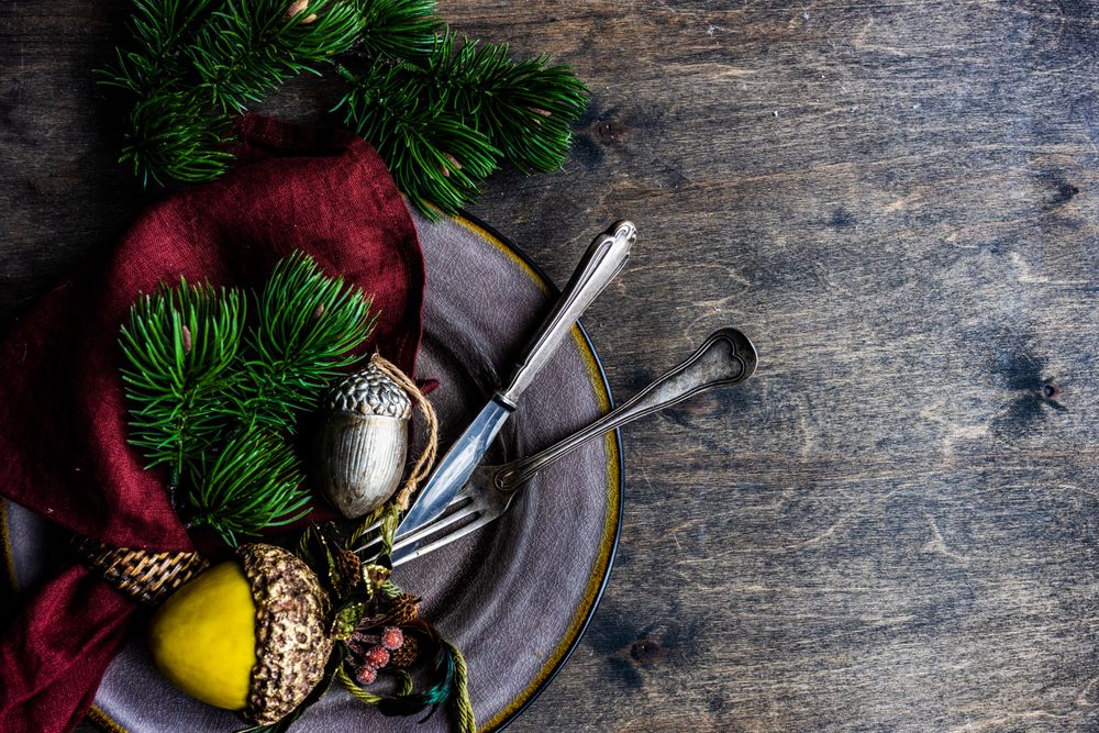 Plate with Christmas ornaments on wooden table