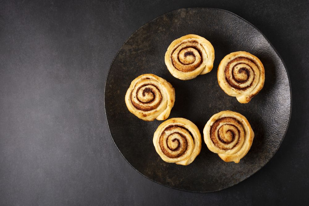 Cinnamon rolls on dark background.