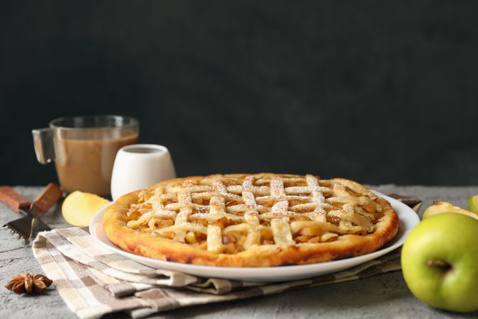 Composition with apple pie and ingredients on gray background. Homemade food