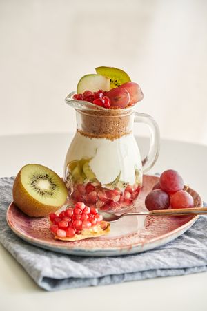 Delicious yogurt dessert with pomegranate, kiwi, grape and ginger biscuit