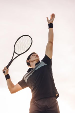 Professional tennis player hitting a serve