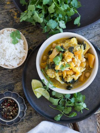 Plate with vegetarian curry on tray