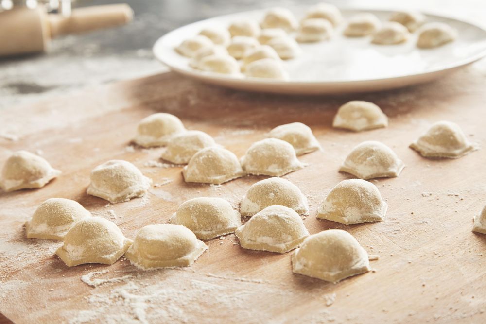 Fresh and homemade ravioli on breadboard